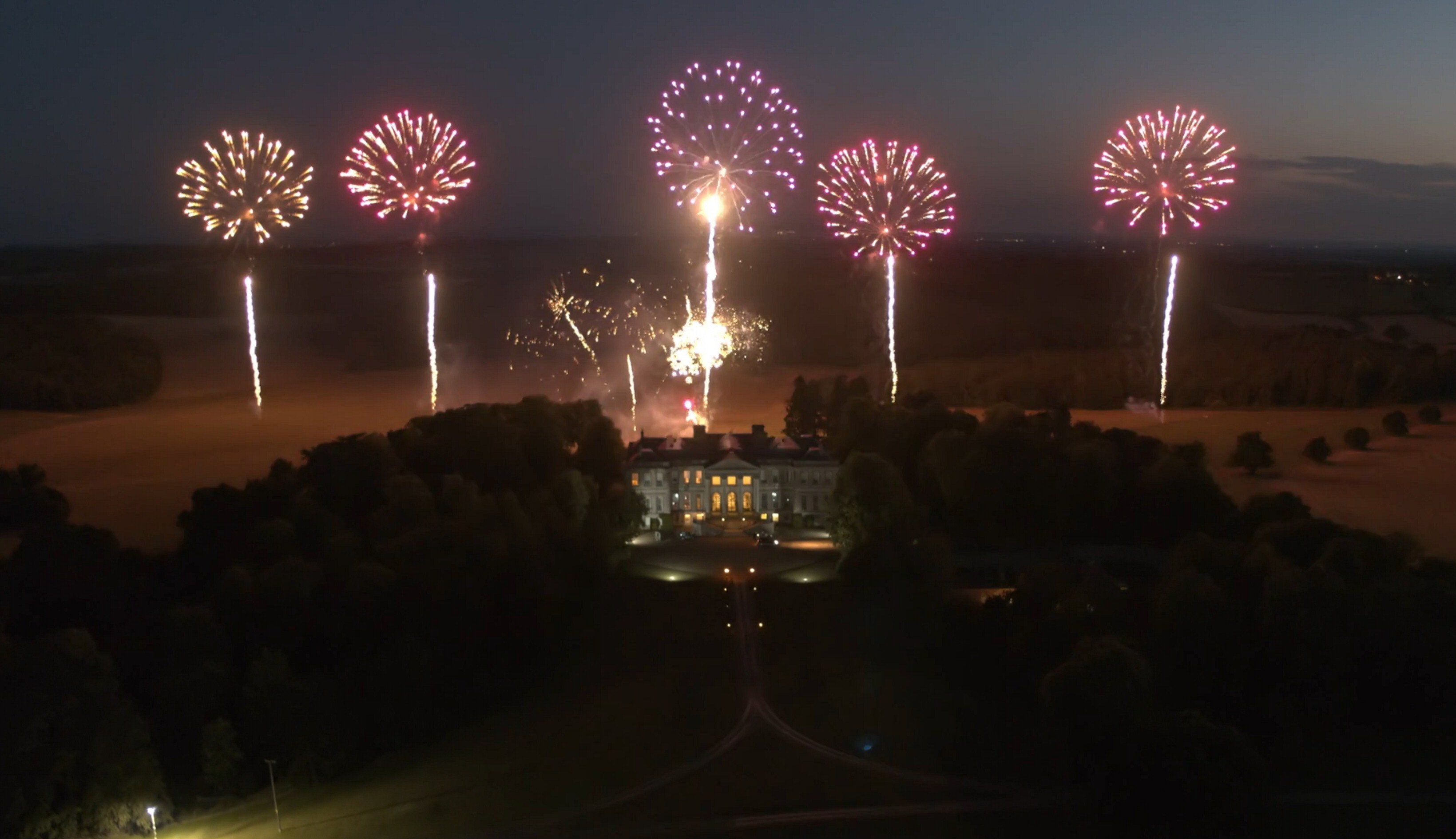An aerial view of fireworks above Ragley Hall